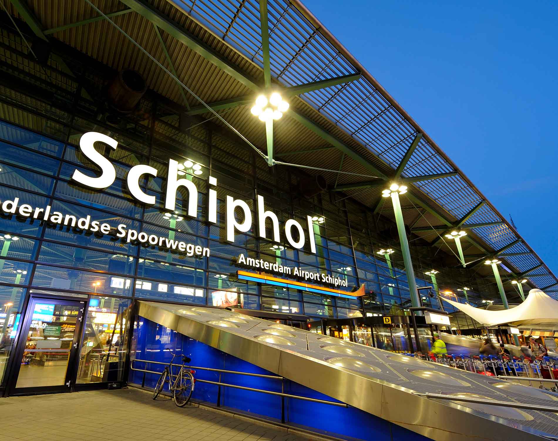 Illuminated entrance of Amsterdam Airport Schiphol at night